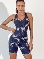 Woman wearing a navy blue tie-dye jumpsuit on a white background