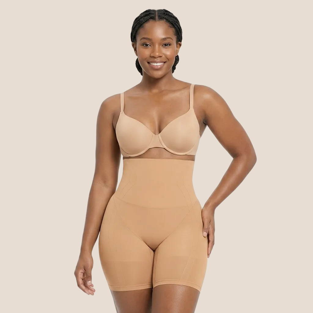 Woman wearing a beige shapewear bodysuit on a white background