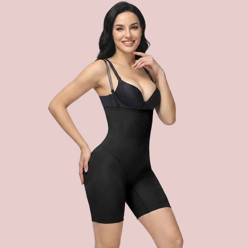 Woman wearing a black shapewear garment on a gray background