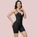 Woman wearing a black shapewear garment on a gray background