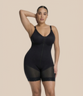 Woman wearing a black shapewear bodysuit on a white background