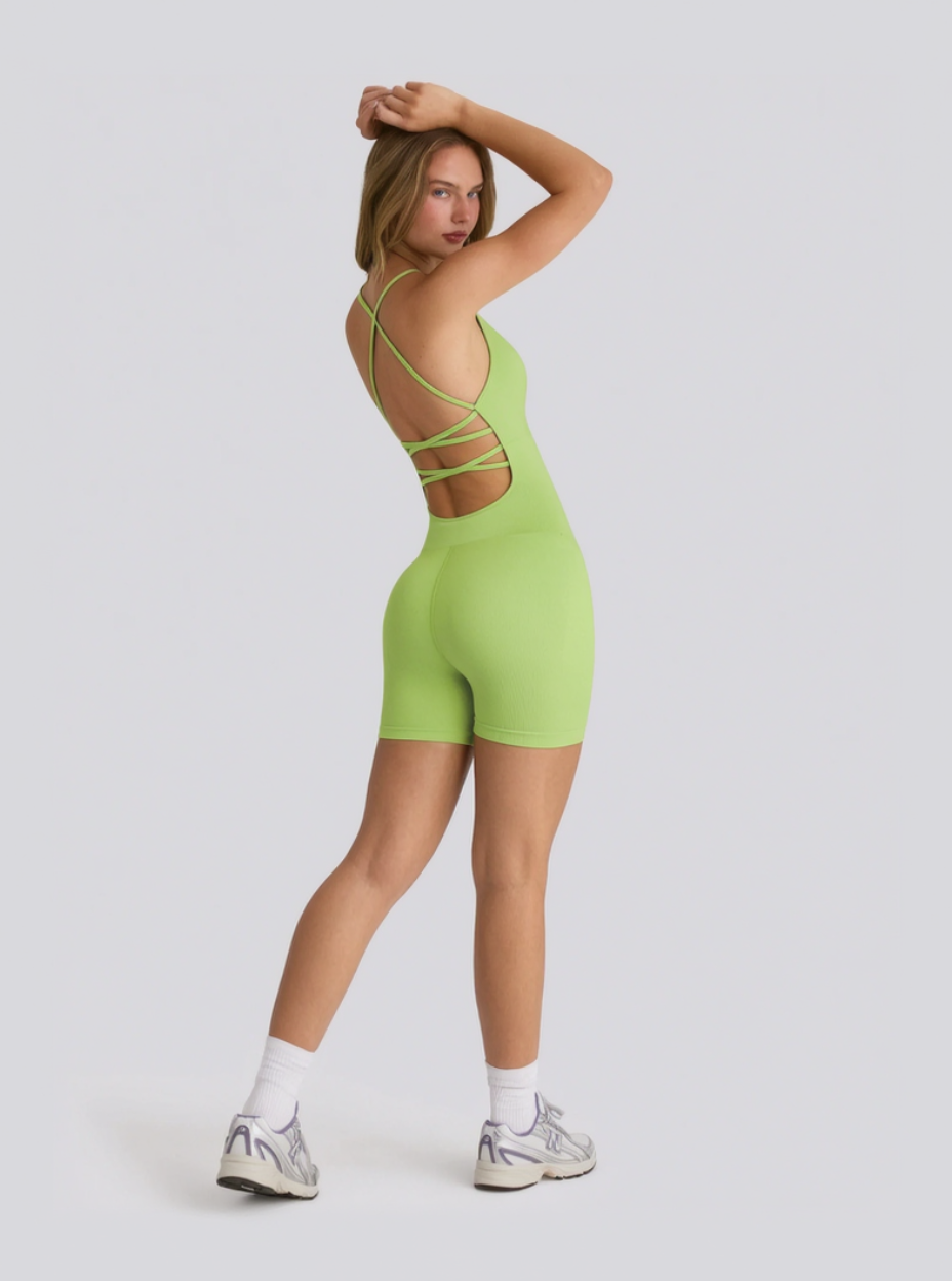 Person wearing a green strappy outfit on a white background