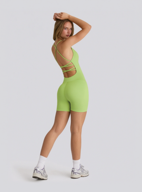 Person wearing a green strappy outfit on a white background