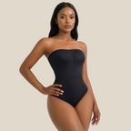 Woman wearing a black strapless bodysuit on a white background