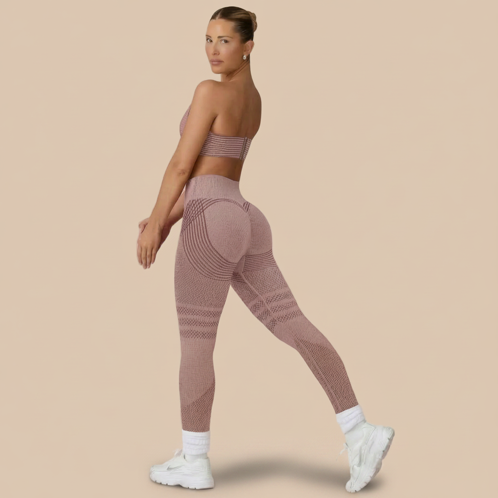 Woman wearing a pink athletic outfit on a pink background