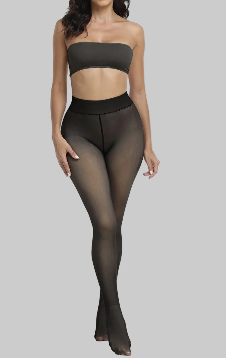 Woman wearing black tights and a matching strapless top on a white background